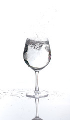 Ice splash in a glass wine of water