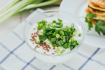 Creamy salad dressing with grated herbs on top