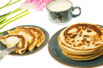 Tasty fried pancakes with milk in cup