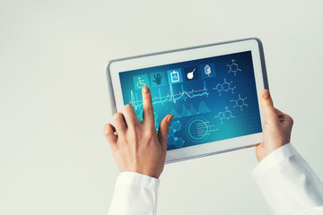 Close of female doctor hands working with tablet pc computer