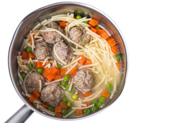 Soup with meatballs on white background