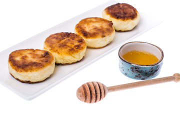Fried curd cheese cakes on white background.