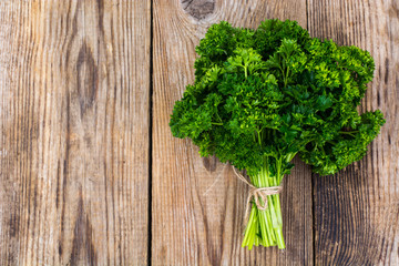 Organic fresh parsley on wooden surface