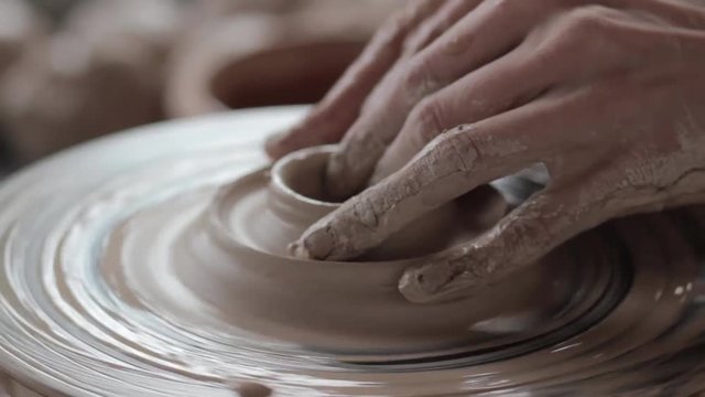 Working behind a potter's wheel
