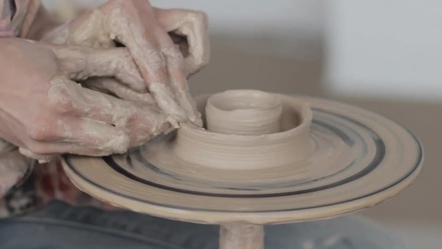 Working behind a potter's wheel
