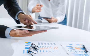 Business people working together and using digital  tablet at a workplace