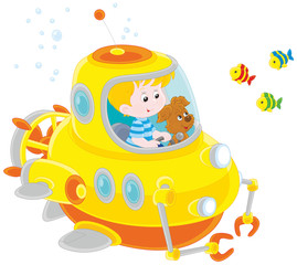 Toy deep-sea bathyscaphe piloting by a little boy with his pup