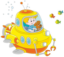 Toy deep-sea bathyscaphe piloting by a little boy with his pup
