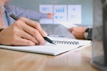 business executives discussing documents and ideas at meeting in a modern office