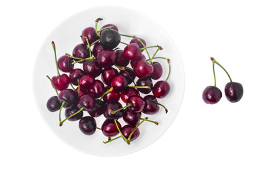 Seasonal fruit: aromatic sweet ripe cherry in plate isolated on 