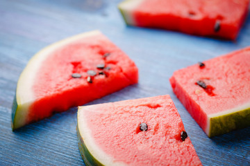 Slices of ripe watermelon on a blue countertop