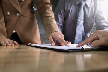 business executives discussing documents and ideas at meeting in a modern office