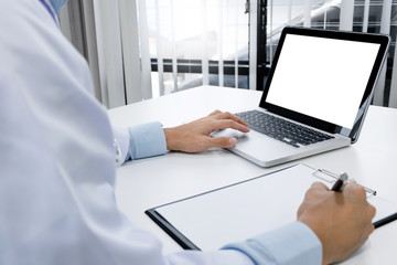 doctor hand typing on keyboard with blank screen laptop