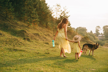 mother walk with his little daughter, and their dog