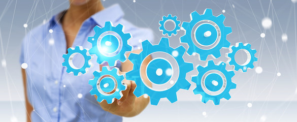 Businesswoman touching colorful gear icons with her finger 3D rendering