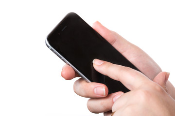 Female hand holding modern black mobile smart phone with blank screen isolated on a white background