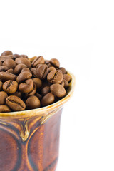 Coffee beans in a small cup on a white background. Isolated