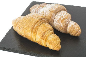 Two croissants on plate on white background. 