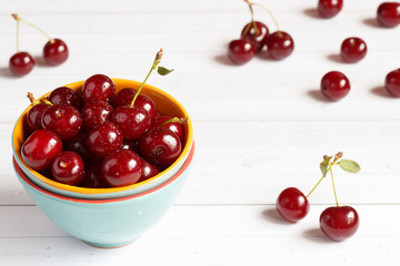 Fresh cherry on plate on wooden background. fresh ripe cherries