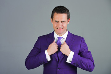 man holding collar in elegant violet formal suit jacket