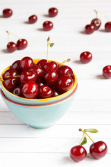 Fresh cherry on plate on wooden background. fresh ripe cherries