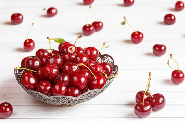 Fresh cherry on plate on wooden background. fresh ripe cherries