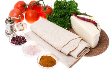 Thin pita bread, tomatoes, cheese and greens for making a light,