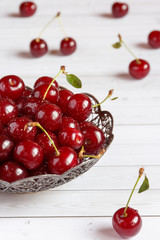 Fresh cherry on plate on wooden background. fresh ripe cherries