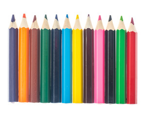 Fototapeta premium Line of colored pencils on white background