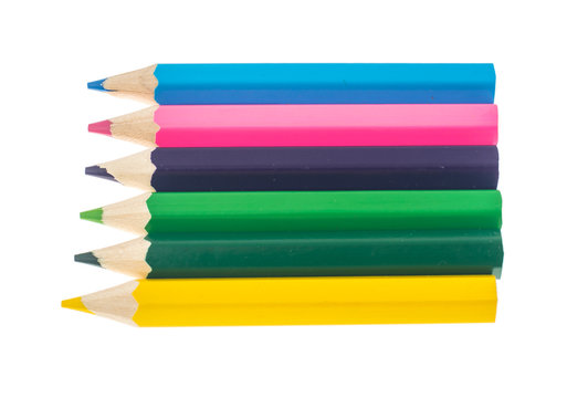 Line of colored pencils on white background