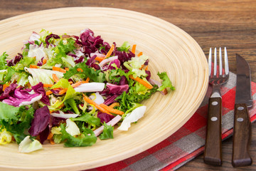 Mix salads with pomegranate and ham