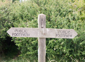 Stock Photo - double wooden post public footpath sign outside leading way