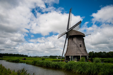 Dutch windmill with cloudy sky in the summer