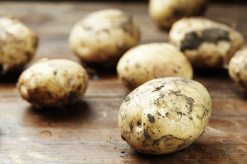 potato is scattered on a wooden background
