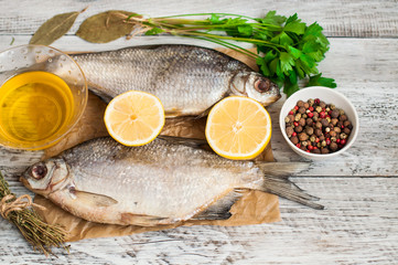 Fish and spices for pickling on a wooden background. Close-up. A banner for a restaurant.