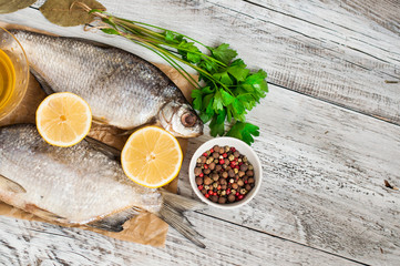 Fish and spices for pickling on a wooden background. Close-up. A banner for a restaurant.