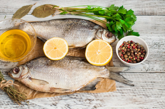 Fish and spices for pickling on a wooden background. Close-up. A banner for a restaurant.