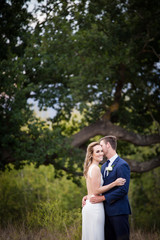 Beautiful bride and her groom on their wedding day looking happy and in love at the start of their marriage