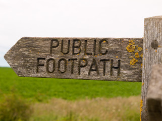 Stock Photo - public footpath wooden sign outside leading way country