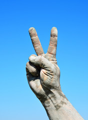 Male hand is raised up and demonstrates a victory gesture