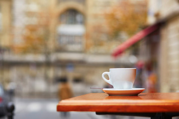 Cup with hot beverage in Parisian outdoor cafe