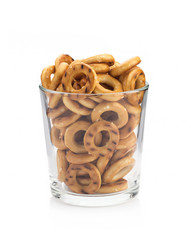 Biscuits with salt in a transparent glass on a white background