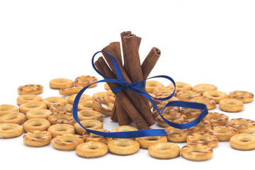 Biscuits with salt, cinnamon sticks on white background