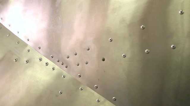 Aircraft fuselage close up. Metal and rivets.