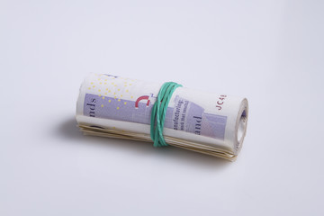 Warsaw, Poland - July 1, 2017: British currency. Roll of twenty pound notes held by rubber band