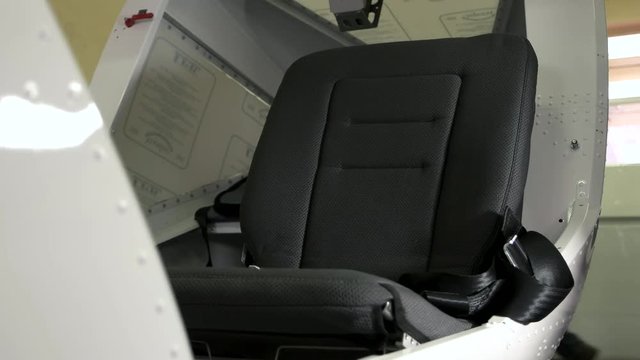 Hand and seat of aircraft. Airline seat with belt. Passenger comfort and safety.