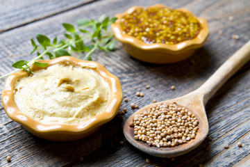 Mustard on wood with mustard seeds