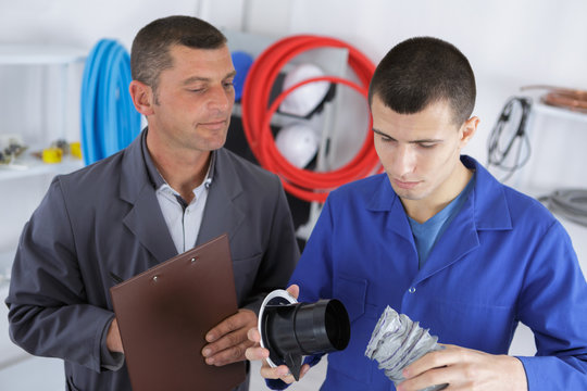 plumber teacher supervising his student