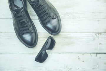sun glasses and leather shoes