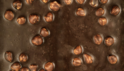 Chocolate background. chocolate with hazelnuts close-up.